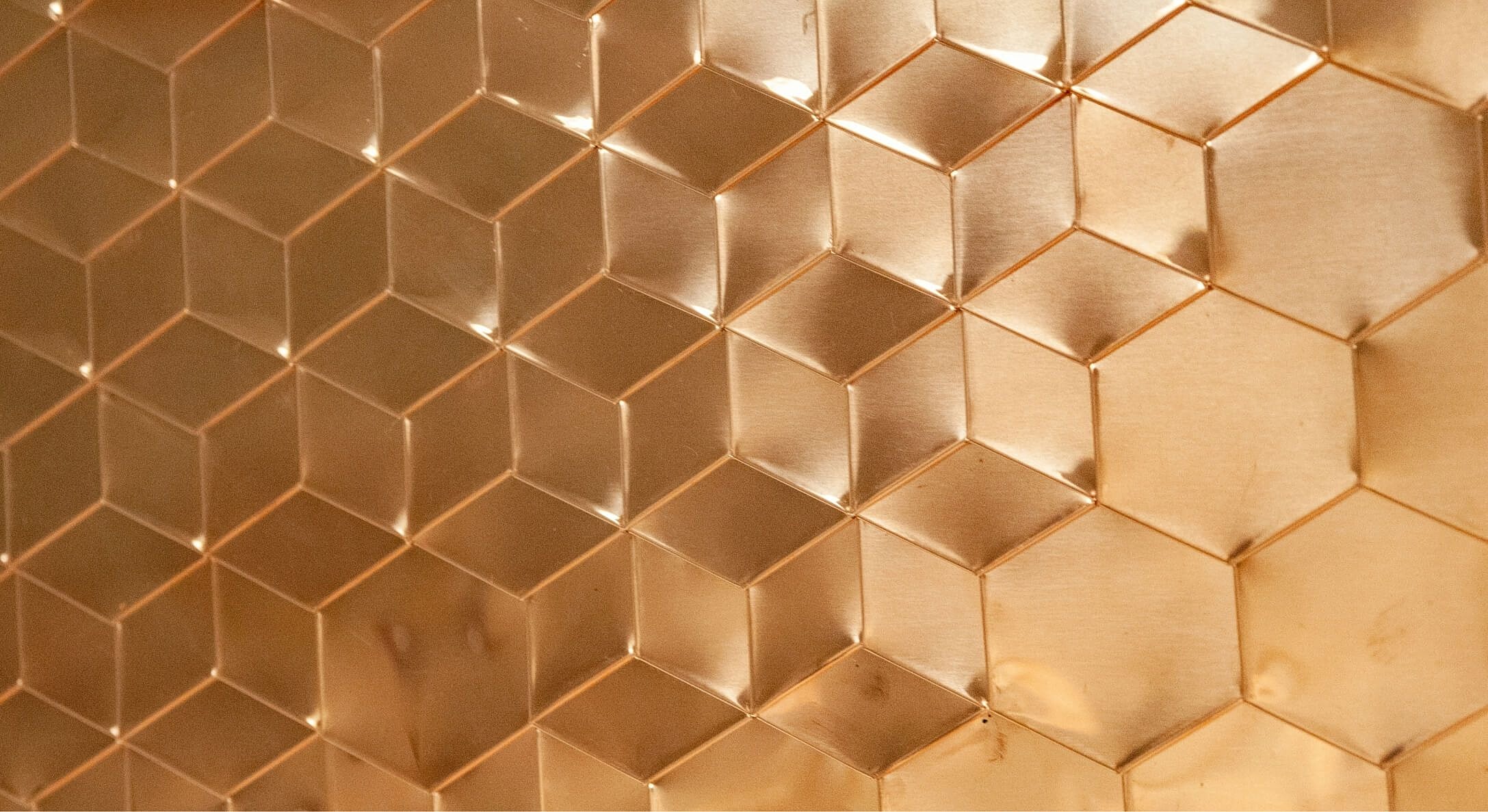Textured hexagonal copper wall panel background.