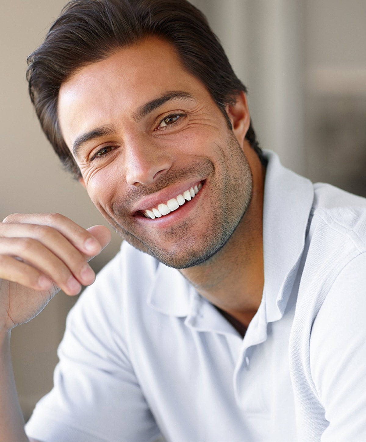 Smiling man in a casual white polo shirt.