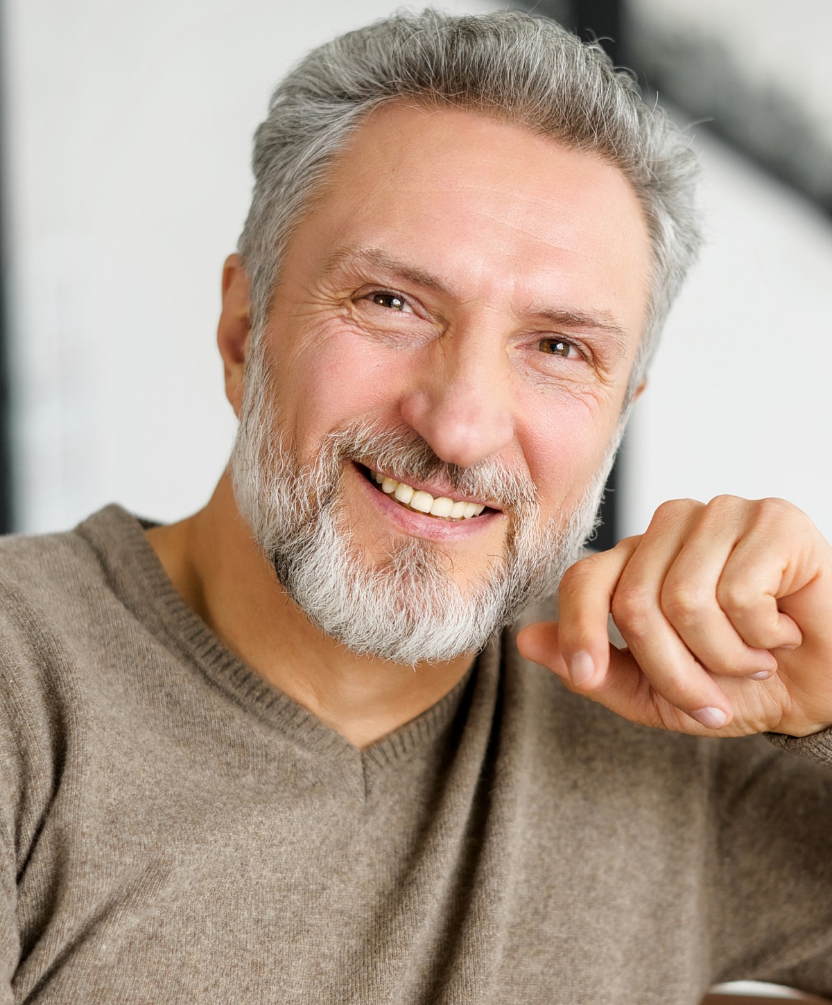 Smiling older man with a gray beard.