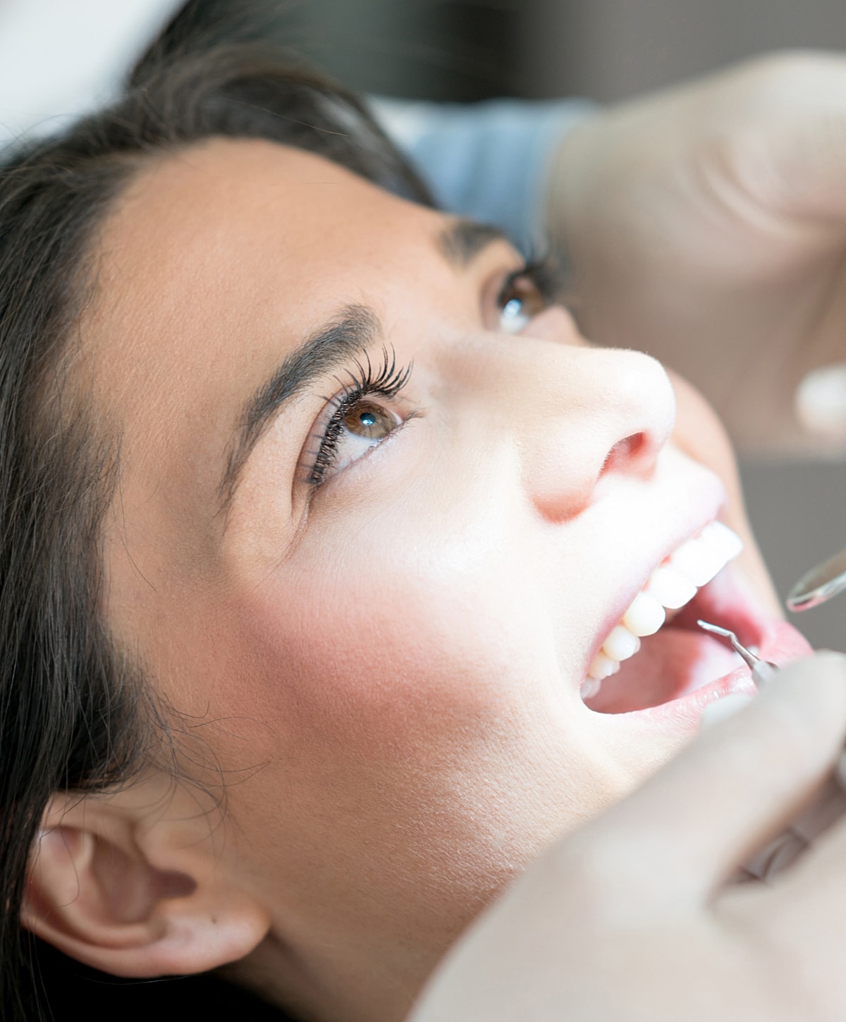 Patient during dental examination in office setting.
