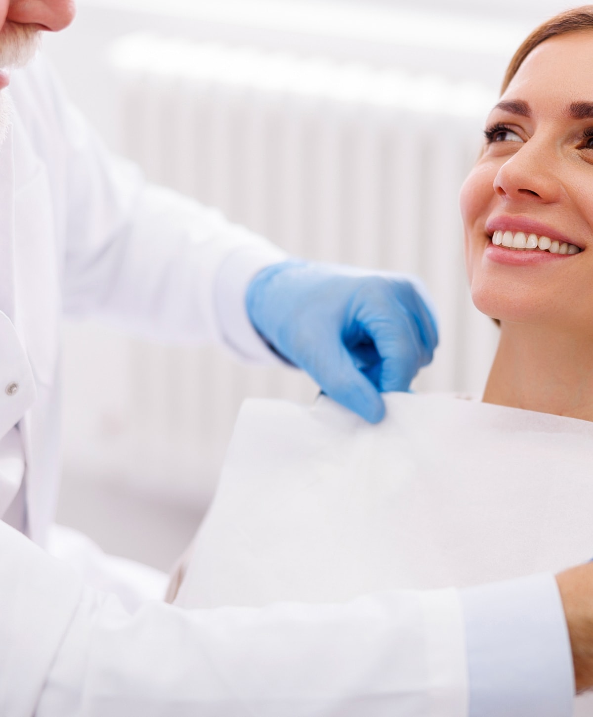 Dentist preparing patient for dental procedure.